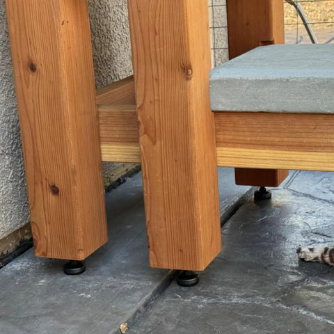 Heavy Duty Adjustable Leveling Feet Kit With M10 Thread And T Nut For Workbenches Cabinets Sofas And Uneven Floors Includes 12 Pack No Sweat Installation showing installed underneath wooden bench leg