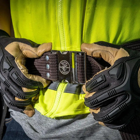 Person fastening the 2 Inch Wide Electrician Tool Belt, Adjustable Up To 48 Inch Waist, Beefy Nylon Webbing With Quick Release Metal Buckle.