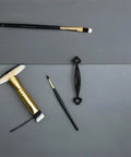 Vintage Zinc Alloy Cabinet Door Handles 10 Pack Black Curved Gate Pulls with brushes on gray surface