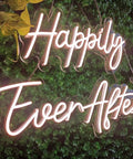 Two Piece Dope Happily Ever After LED Neon Light Sign Set Warm White With Dimmer, displayed on greenery backdrop.