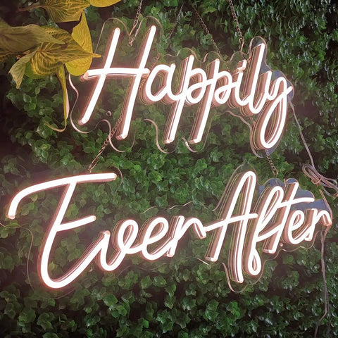 Two Piece Dope Happily Ever After LED Neon Light Sign Set Warm White With Dimmer, displayed on greenery backdrop.