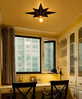 16 Inch Industrial Black Metal Star Flush Mount Ceiling Light With Vintage Farmhouse Vibe installed in a study room.