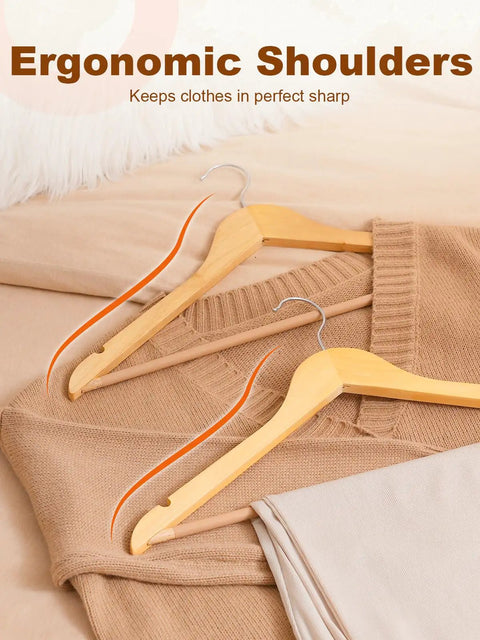 Heavy Duty Wooden Hangers 20 Pack With Non Slip Pant Bar For Closets displayed with clothes on bed