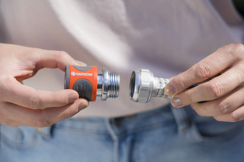 Premium Metal Quick Connect Hose Fittings Set For Five Eighths Or Half Inch Hoses being connected by hands