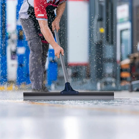 Built Like A Tank 30 Inch Silicone Floor Squeegee With Rust Resistant Stainless Aluminum Pole used for cleaning water off concrete.