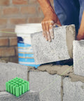 Green Plastic Drywall Anchor Kit With Self Tapping Screws For Gypsum Wallboard shown with bricklaying in background