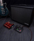 Electric guitar with HX Stomp Multi Effects Guitar Pedal with over 300 effects Helix M Series and amp cab setup on dark wood floor