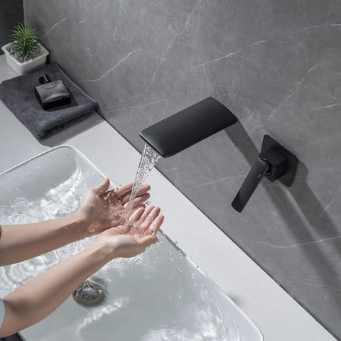 Wall Mount Waterfall Bathroom Faucet Matte Black for Vanity Sink, Single Handle, showing water flowing into a basin