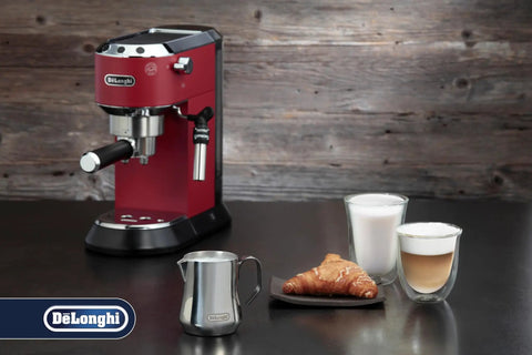 12 Oz Stainless Steel Milk Frothing Jug With Barista Grade Pour Spout For Smooth Silk Foam next to espresso machine and coffee setup.