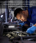 Mechanic using 90 Degree Grease Coupler Adapter With Sleeve For Tight Spaces Right Angle Grease Gun Fitting in car engine bay