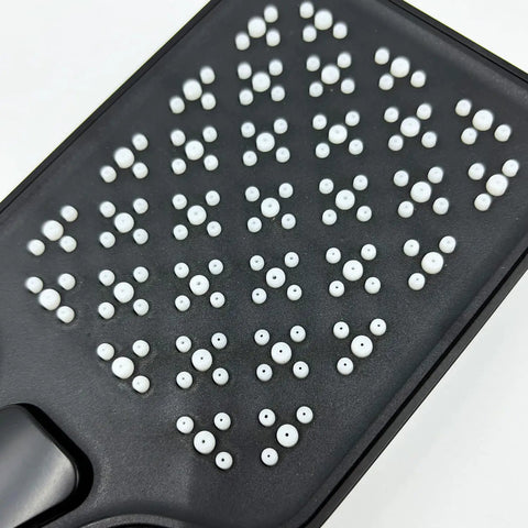 Close-up of the spray face with easy-clean silicone nozzles of the matte black handheld shower system.