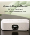 Knockout Portable Ultrasonic Cleaner For Glasses And Jewelry Using High Frequency Vibration And Eco Friendly Deep Wash Tech To Make Your Treasures Look Slick And Sparkling Fresh In Pink on a table with a timer display.