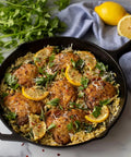Cooked dish with lemon in a skillet from 5 Piece Cast Iron Cookware Set With Skillets Griddle And Dutch Oven Preseasoned PFAS Free Non Toxic Even Heat Performance For Stove Oven And Campfire Cooking