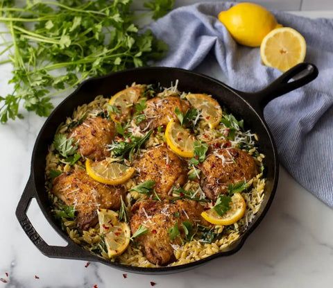 Cooked dish with lemon in a skillet from 5 Piece Cast Iron Cookware Set With Skillets Griddle And Dutch Oven Preseasoned PFAS Free Non Toxic Even Heat Performance For Stove Oven And Campfire Cooking