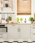 Modern kitchen with sleek cabinet hardware and plants on countertop