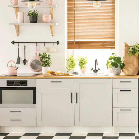 Modern kitchen with sleek cabinet hardware and plants on countertop