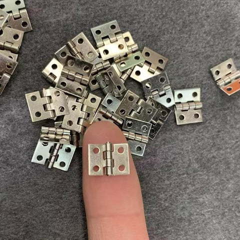 1:12 Scale Miniature Door Hinges With Screws, Set Of 4 For Dollhouse Doors And Cabinets, silver hinges shown on fingertip