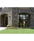 Building exterior with XTOR1B Cross Tour Carbon Bronze 12W Low Profile Small Housing Outdoor Integrated LED Wall Pack Light
