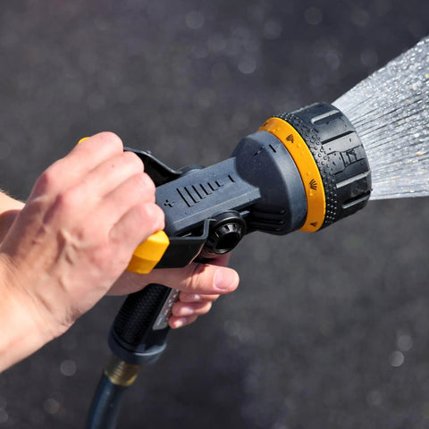 Close-up of hand using Torrent Firemans Nozzle With Quick Connect Set Go-To Seven Spray Patterns Metal Core Durable Rubber Coating