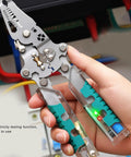 Kickass 12 In 1 Wire Stripper And Crimper Pocket Multitool Pliers showing electricity testing function and grip design.