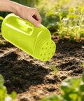 Adjustable Handheld Seed Shaker And Spreader For Fertilizer Grass Seed Ice Melt And Lawn Care in use in a garden