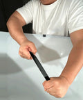 Man demonstrating the flexibility of Battle Ready Aluminum Roof Repair Tape Heavy Duty Self Adhesive Waterproof Shingle Sealant Strip.