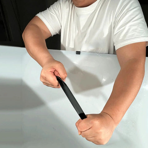 Man demonstrating the flexibility of Battle Ready Aluminum Roof Repair Tape Heavy Duty Self Adhesive Waterproof Shingle Sealant Strip.