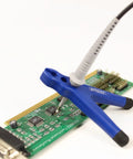 Secure Hands Free Oscilloscope Probe Positioner With Two Feet For Exact Safe Testing And Tapered Opening That Fits Various Probe Shapes In Blue holding probe on circuit board.