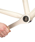 Hand using BBT-29 Double-Ended Bottom Bracket Tool For 16-Notch Cups 39mm And 48.5mm on bicycle frame bracket