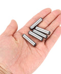 Hand holding five Beefy 5/16 Inch By 1-1/4 Inch Dowel Pins in heat-treated alloy steel, bright finish, for precise alignment.