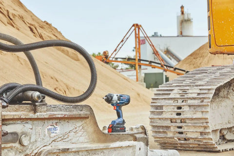 Heavy Duty 18 Volt Cordless Impact Wrench With Half Inch Drive Friction Ring and Beast Mode Torque for Stubborn Bolts at a construction site.