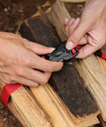 Hands using Beefy Outdoor Nylon Luggage Straps With Quick Release Buckle 1.5m Heavy Duty Camping Tie Down Straps on firewood
