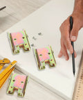 Four Sets Golden Metal Folding Cabinet Door Hinges 90 Degree Self Locking Mechanism shown on table with installation tools