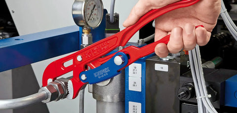 Swedish Pattern Pipe Wrench With S Shape Fast Adjust And Self Locking Action in use on plumbing fittings, hand holding tool.