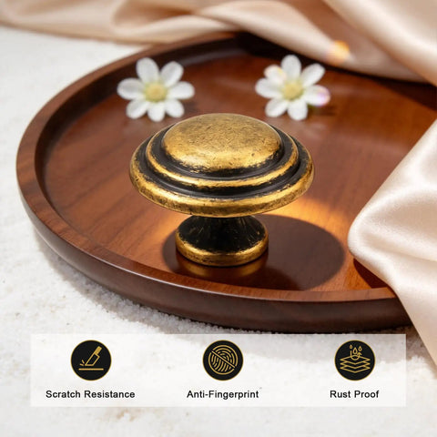 10 Pack Antique Brass Round Top Ring Cabinet Knobs, 35mm Diameter Zinc Alloy Handles, displayed on wooden tray with flowers