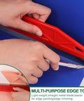 Close-up of red edge tool in Wallpaper Smoothing Tools Kit With Squeegee Smoother Seam Roller And Brush Pro Grade.