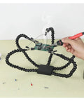 Pro Grade Flexible Third Hand Soldering Station with Four Arms, Adjustable Goosenecks, holding PCB for electronics repair