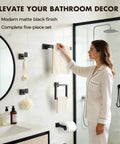 Woman installing Matte Black 5 Piece Bathroom Hardware Set Made Of SUS304 Stainless Steel Wall Mounted Towel Bar and Hooks