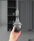 Hand holding A23 Multi Color Rotating Disco LED Light Bulb With Diamond Lens Color Changing Effect, showcasing E26 base