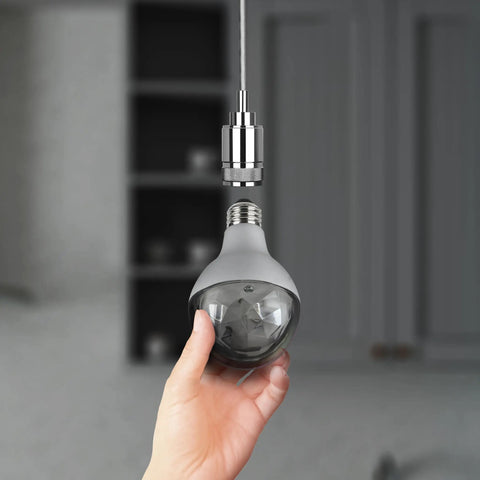 Hand holding A23 Multi Color Rotating Disco LED Light Bulb With Diamond Lens Color Changing Effect, showcasing E26 base