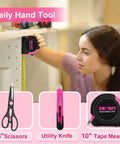 Person using tape measure from Pink 40 Piece Hand Tool Kit Set With Storage Toolbox For DIY Home Office Garage And Dorm Use Includes Hex Keys Screwdriver Bits Bit Driver Magnetic Bit Holder Precision Screwdrivers Hammer Tape Measure Shears Utility Knife And More.
