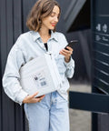 Person holding a package in 10x13 Inch Poly Mailers 200 Pack White For Clothing Shipping Envelopes Tear Resistant