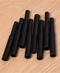 8 Pack Golf Club Shaft Extensions Carbon Fiber 0.49 Inch Small End 0.595 Inch Thick End By 3 Inch Length Black on Wood Surface