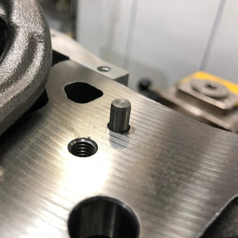 Close-up of M5 x 30mm dowel pin fitting into a metal component, showcasing its cylindrical shape and precision fit.