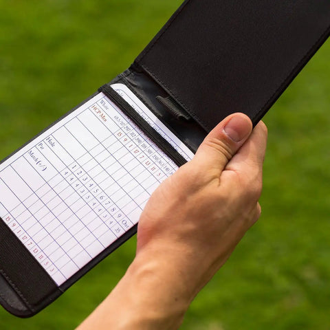 Pro Grade Leather Golf Scorecard Holder For Yardage Books, Durable Black Card Keeper With Secure Clip in use, holding a scorecard.