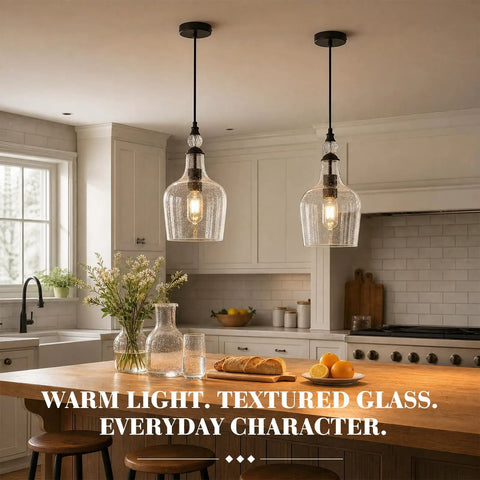 BNHHLZ Seeded Glass Pendant Light for Kitchen Island, Matte Black Teardrop Hanging Light Fixture, Adjustable Cord Modern Farmhouse Ceiling Lamp with Open Bottom above a kitchen island.