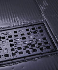 Close-up of Linear Shower Floor Drain With Removable Cover Grid Grate 12 Inch Long Rectangle Stainless Steel Matte Black Finish For Modern Bathrooms Premium 304 Stainless Steel Construction Scratch Resistant Corrosion Resistant Built Tough with water droplets