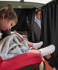 Sleeping child in car with Set Of 3 Car Window Shades With Privacy Divider And Side Window Covers, providing shade and comfort.