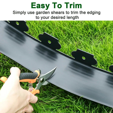 No Dig Landscape Edging Kit 33 Ft Long 4 Inch Tall Black Plastic Border being trimmed with garden shears on grass.