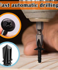 Close-up of self tapping metal screws kit size eight in 410 stainless steel black oxide truss head being drilled into wood.